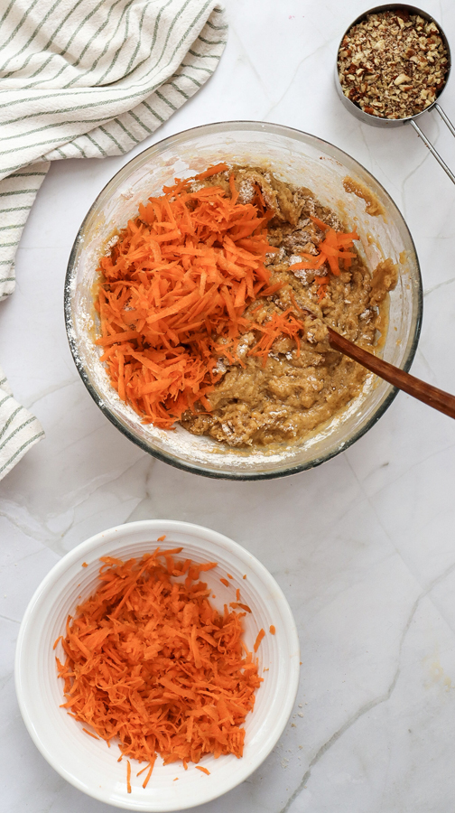fold shredded carrots and nuts into the carrot cake batter