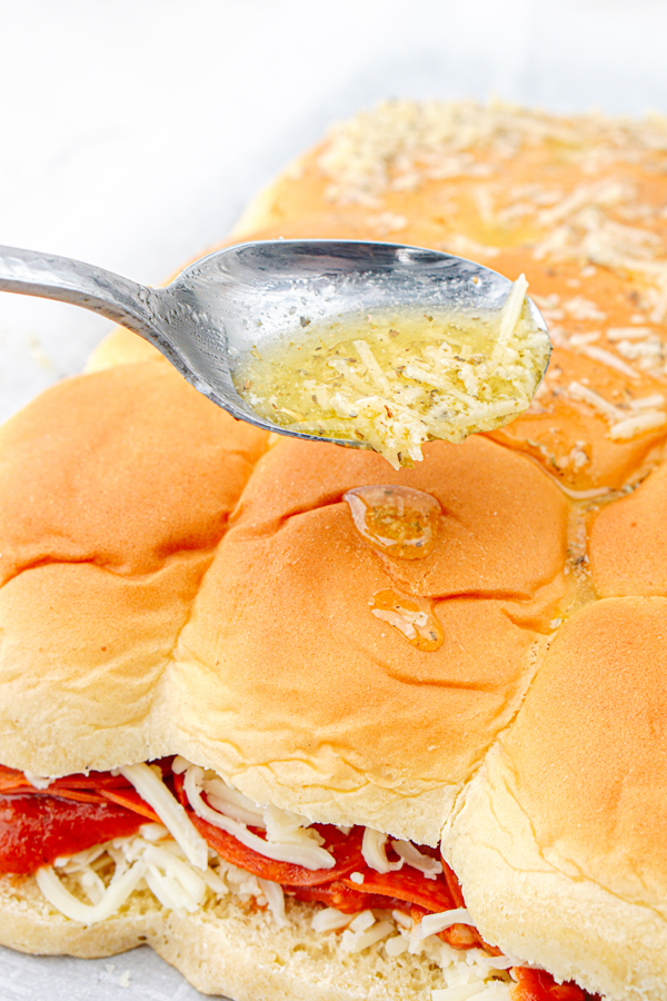 spoon butter mixture on top of rolls