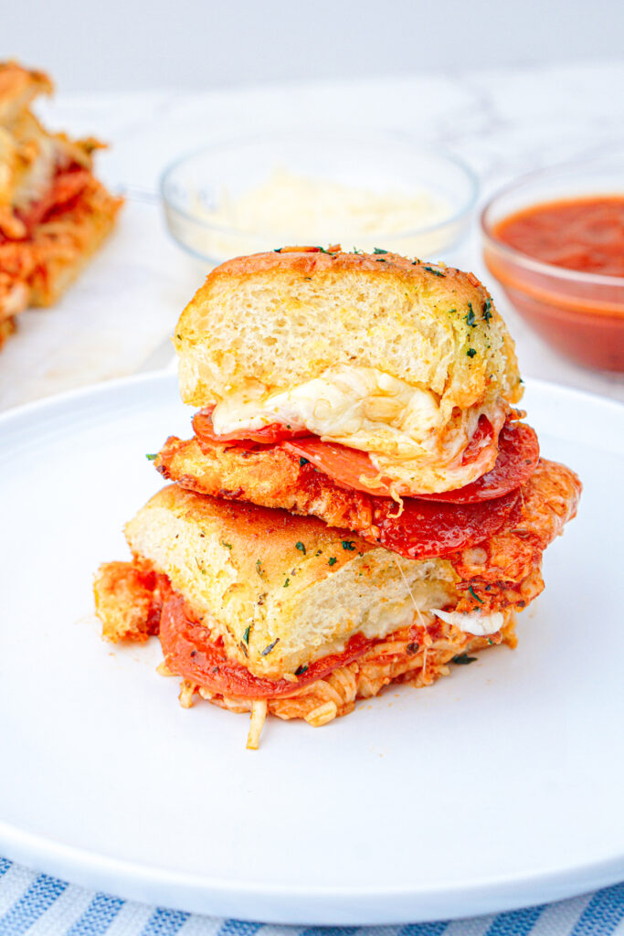 closeup of finished pepperoni pizza sliders on a plate