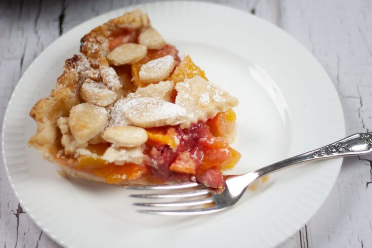 peach mango pie slice with fork