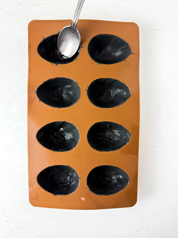 coat the inside of the candy mold with melted chocolate