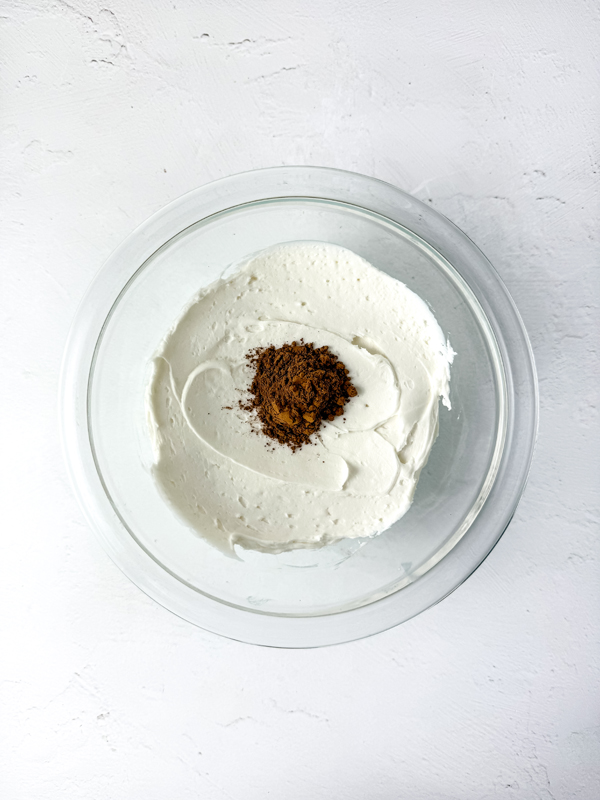 add cocoa powder and brown food coloring to icing until it's a dark shade of brown