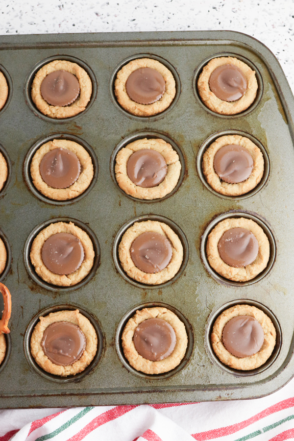 press peanut butter cups into center of each cookie while they're warm