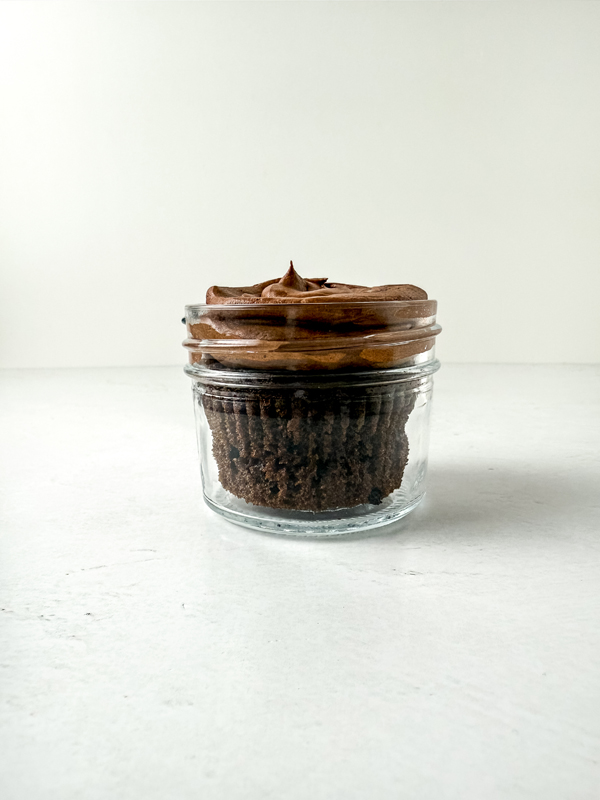 add cupcakes and icing to the jars