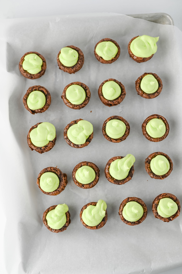 add green frosting to the top of the brownie bites.