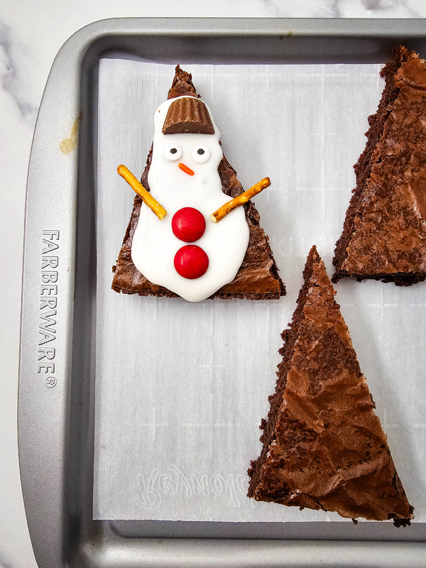 5 decorate snowmen with candy and pretzels
