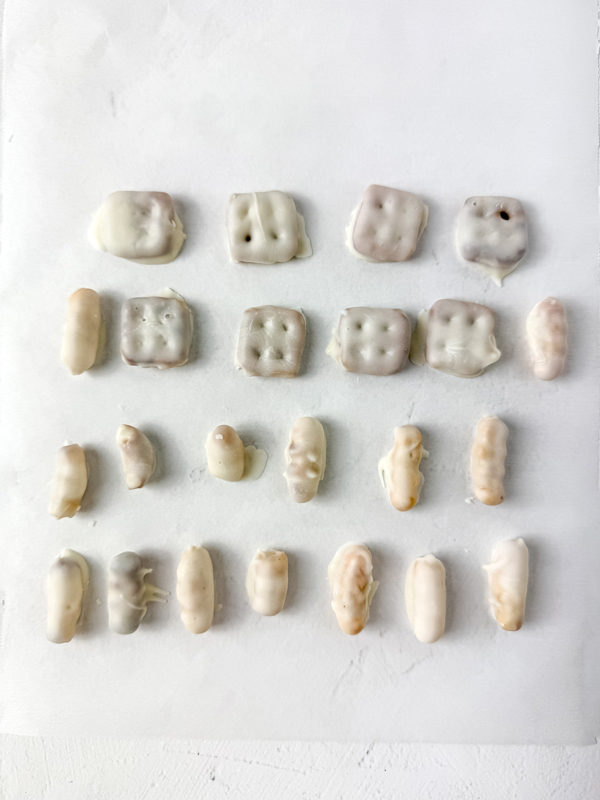 dip the pretzels and squiggle pieces into white candy and allow to dry