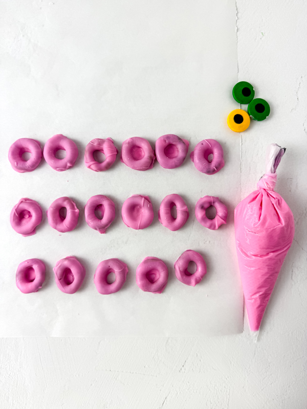 dip the round pretzels in pink candy