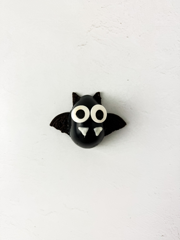 place the candy eyes and create the fangs on each bat