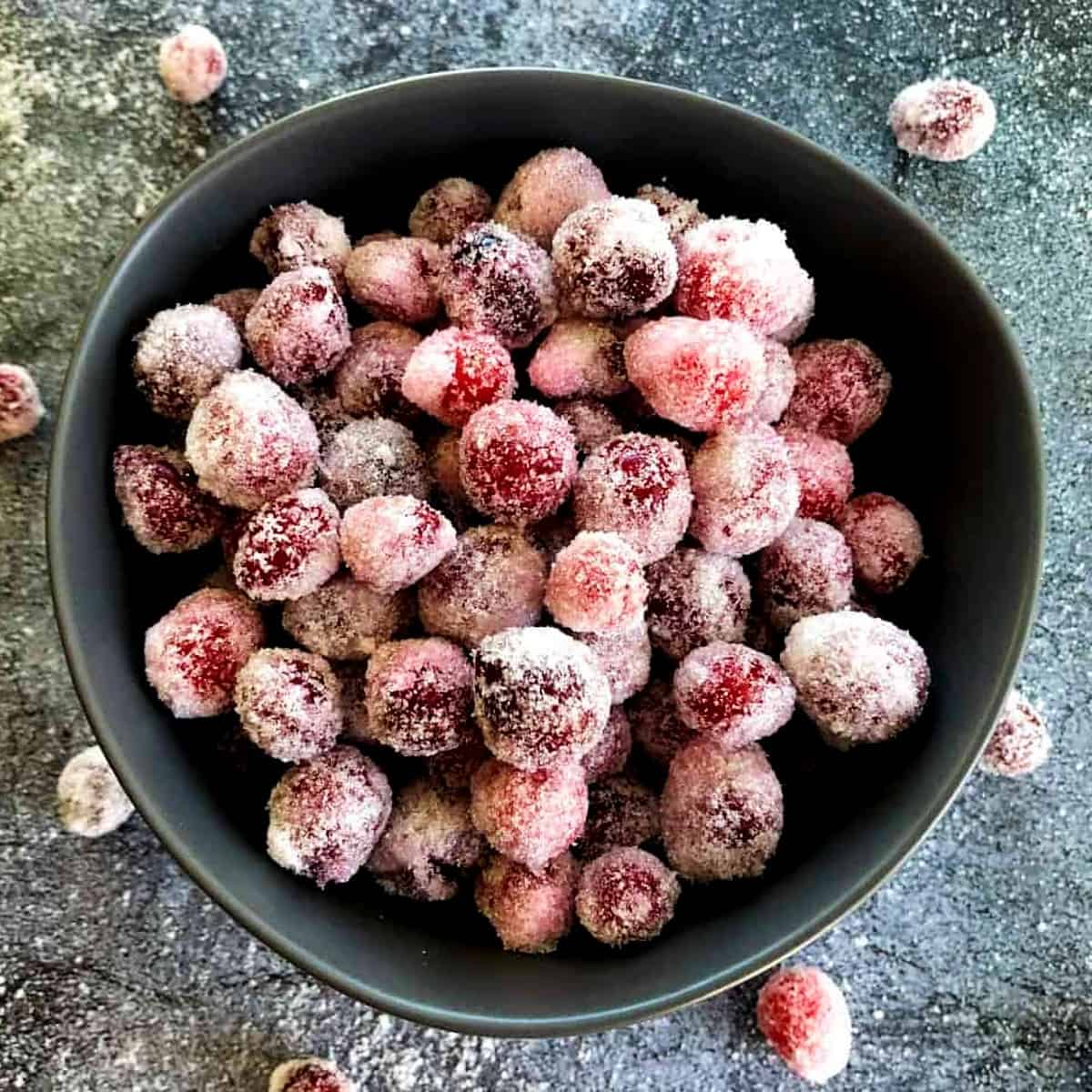 boozy candied cranberries in a bowl with sugar 1