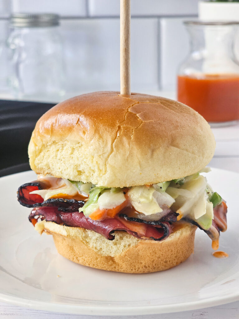 closeup of finished pastrami slider on a plate