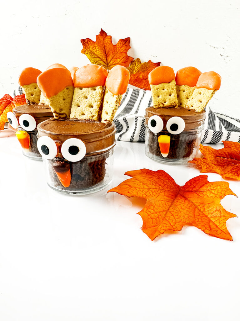 cute turkey cupcake jars on a fall table