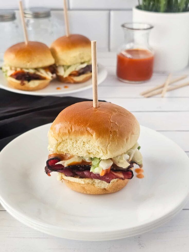 finished pastrami slaw sliders on a plate