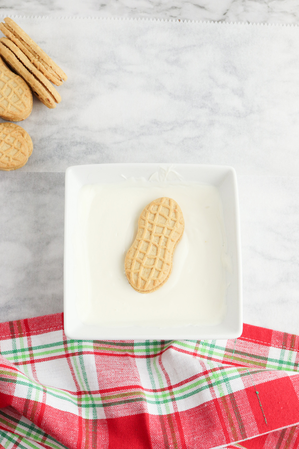dip nutter butter cookie into melted candy