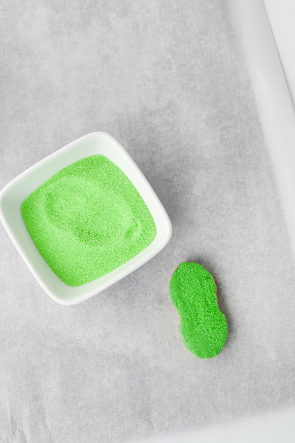 dip the candy coated side of the cookie into the sanding sugar