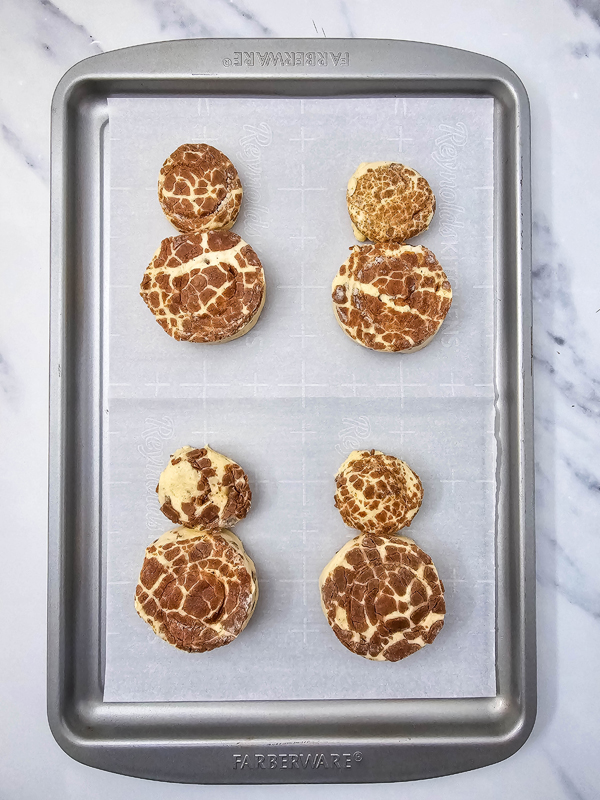 place the cinnamon rolls onto parchment paper