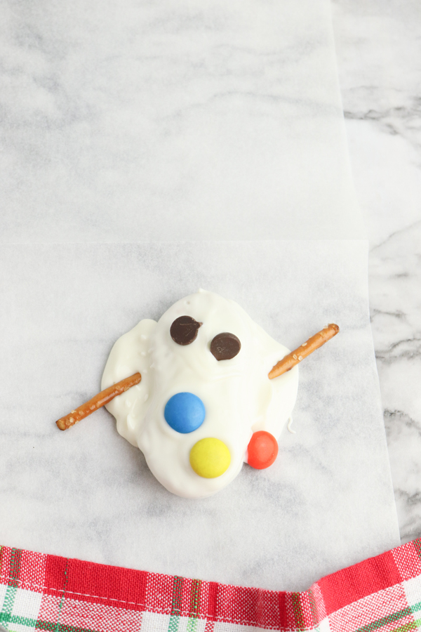 add chocolate chip eyes and m&m buttons