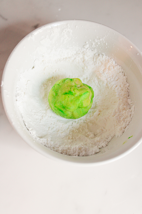 roll cookie dough balls in corn starch and sugar mixture