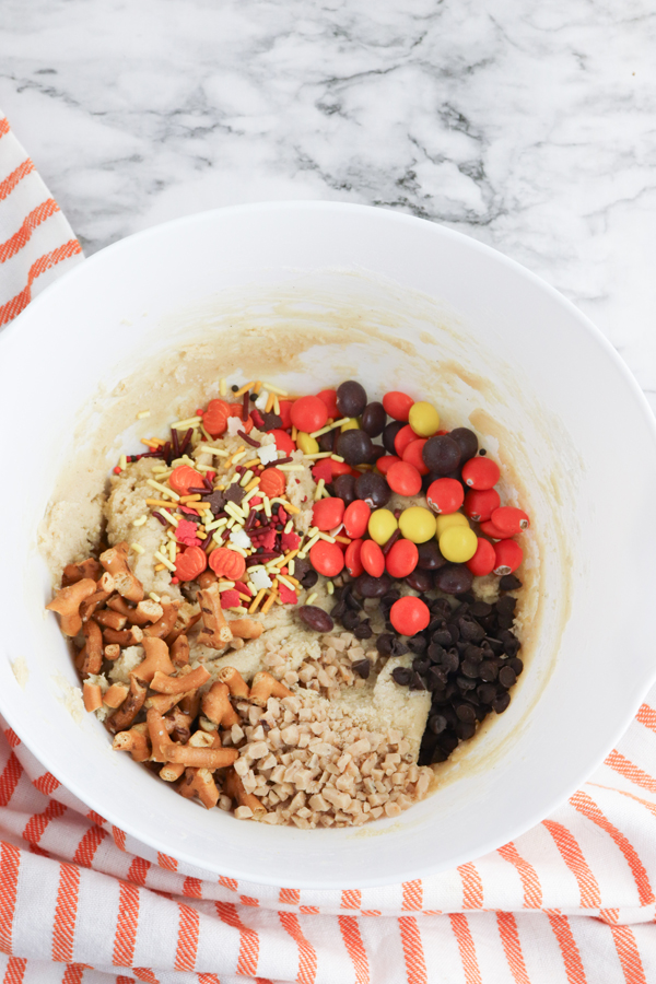 add the chocolate chips, candy, sprinkles, and pretzel pieces.