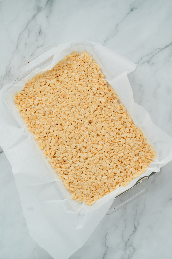 press mixture into a parchment lined pan as evenly as possible