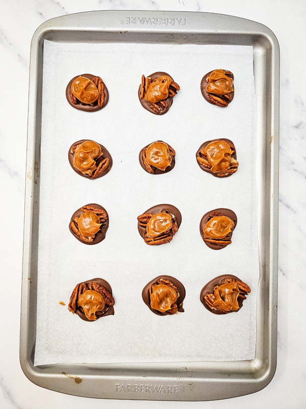 add dollops of caramel on top of pecans