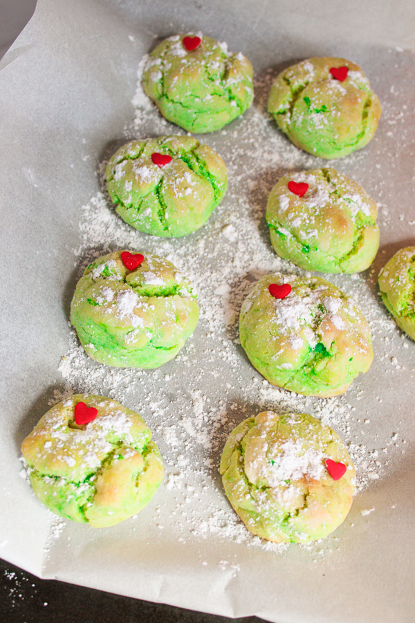 add powdered sugar and candy heart to the top of each cookie