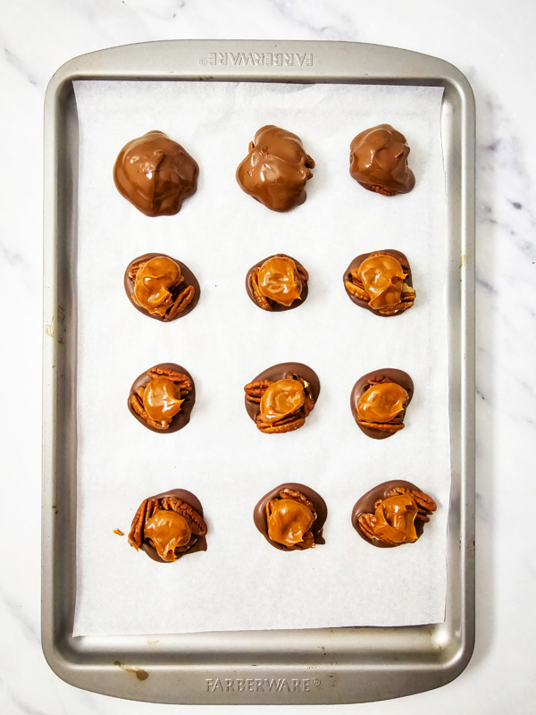 cover caramel and pecans with chocolate and add sprinkles before the chocolate hardens