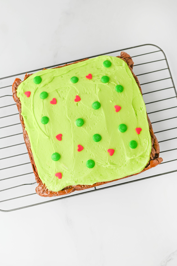 frost the cooled brownies and add green m&ms and red heart candies to the top