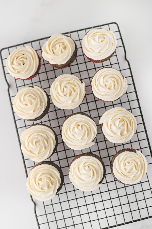 swirl the buttercream frosting over the cooled cupcakes.