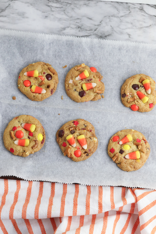 press candy corn into the tops of the warm cookies