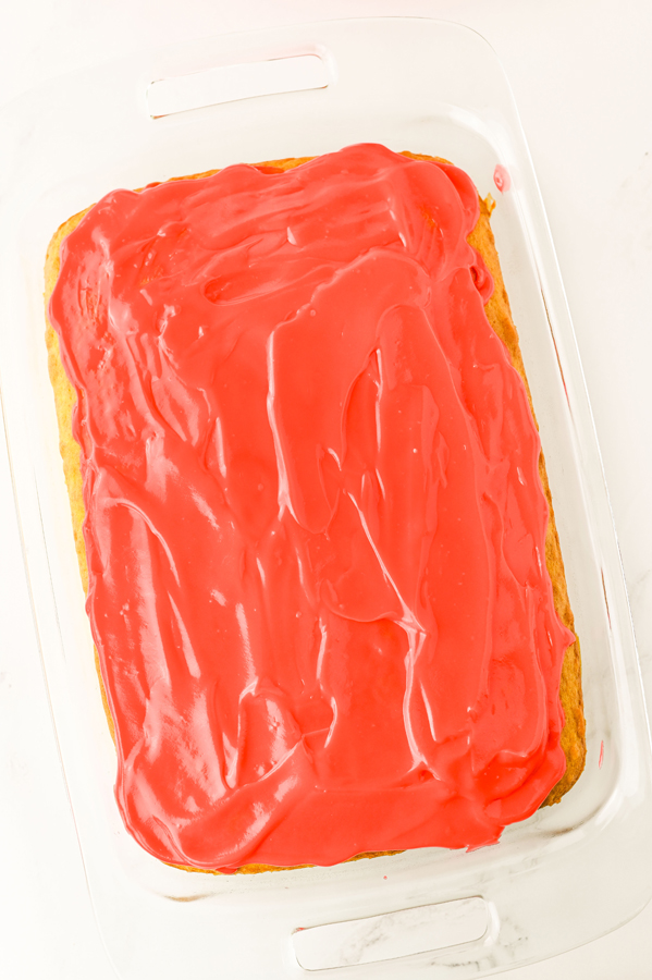 top the cake with red pudding, making sure to add pudding into the holes