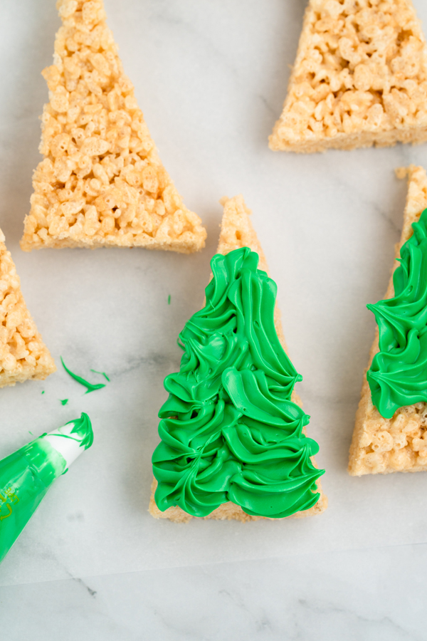 pipe the green icing on the triangles in swooping shapes