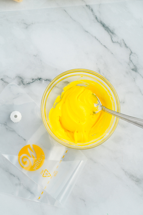 tint the small bowl of icing yellow