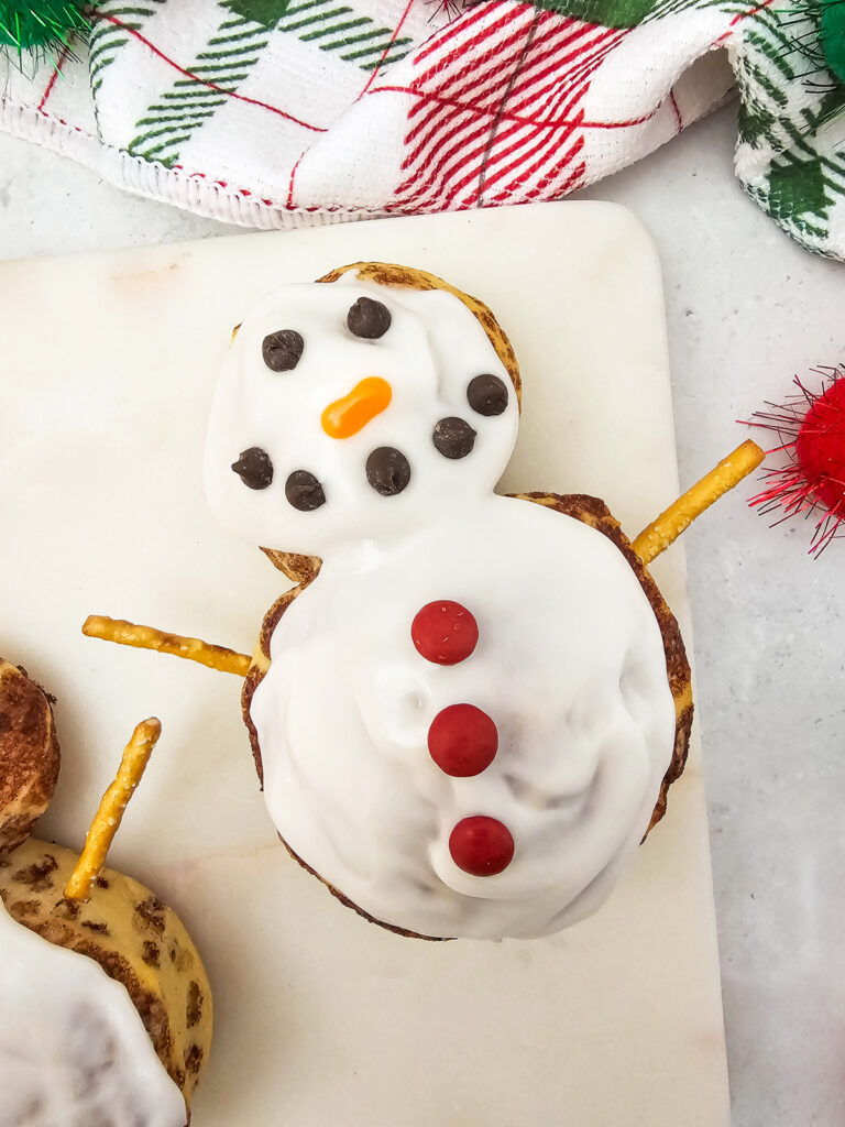 closeup of finished snowman cinnamon rolls