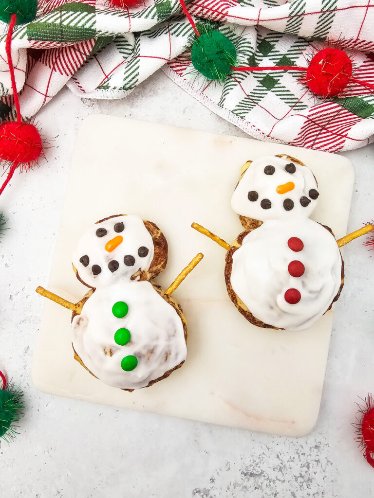 snowman cinnamon rolls on a counter