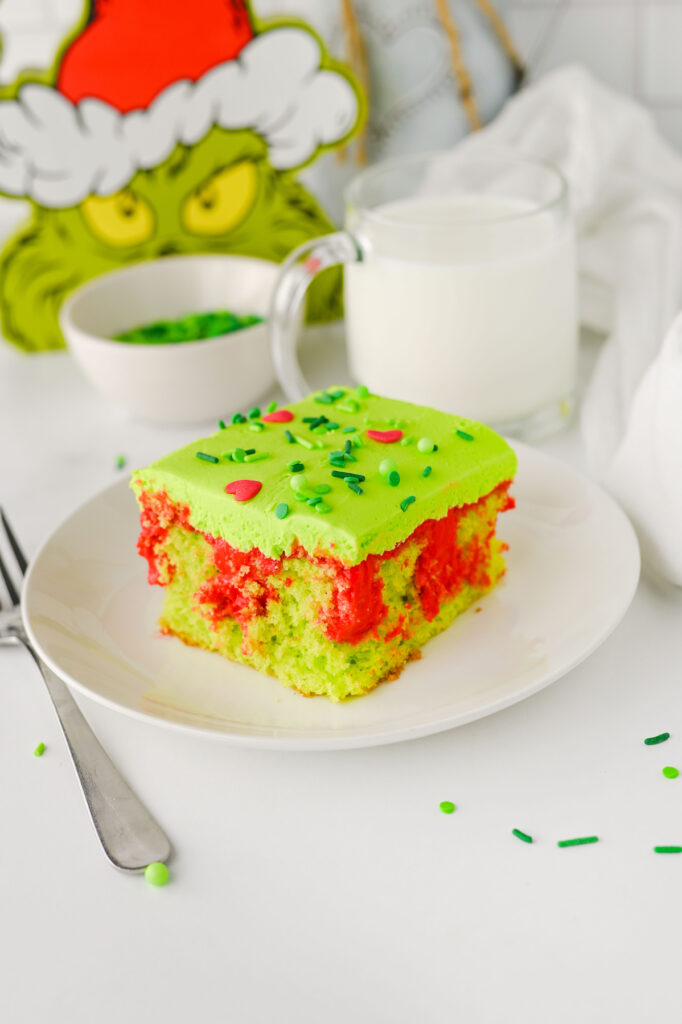 slice of grinch poke cake on a plate