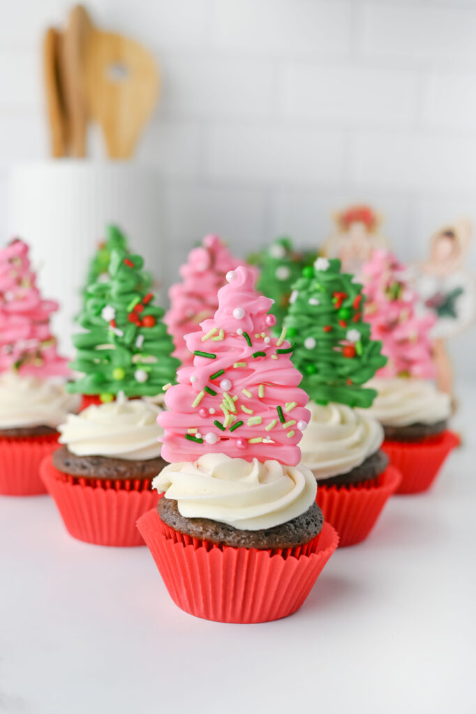 Christmas tree cupcakes on a counter