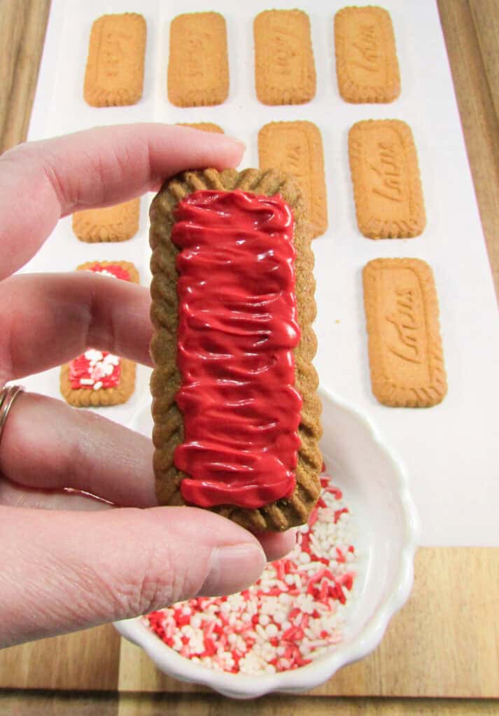 pipe red candy into the center of each cookie with a zigzag motion