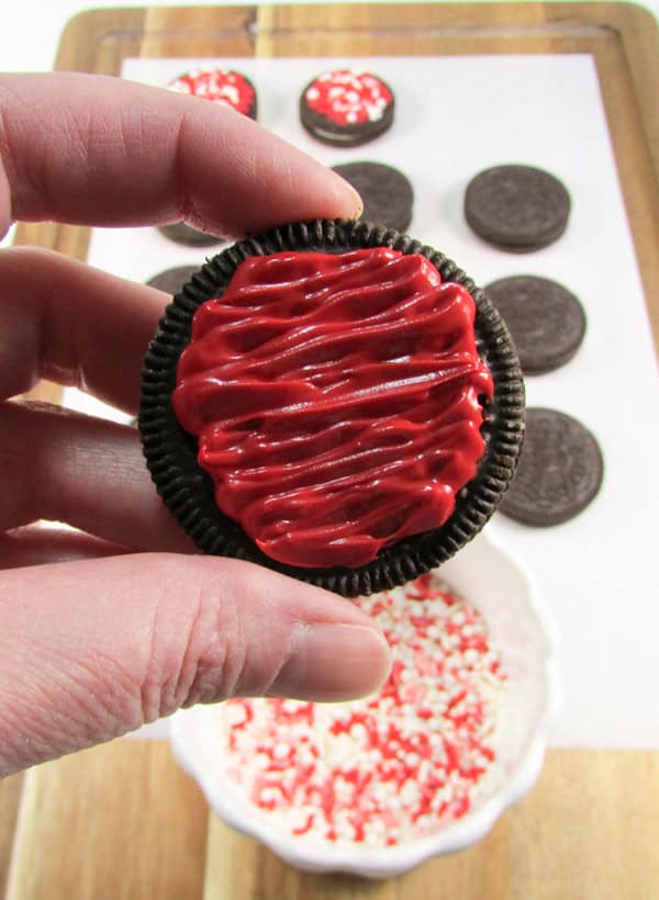 pipe the candy in a zigzag motion across the top of the cookie, leaving the edges bare