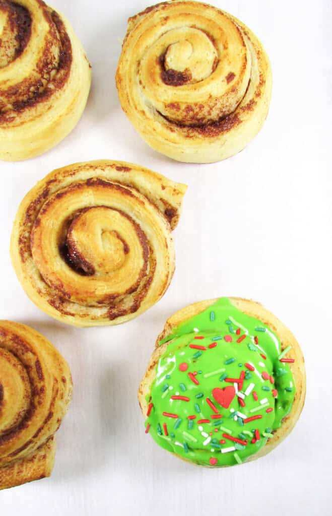 ice and decorate cinnamon rolls one at a time