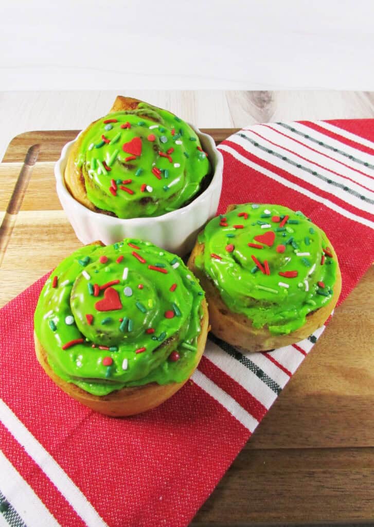grinch cinnamon rolls on a serving board