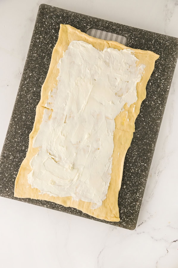 spread cream cheese on top of dough