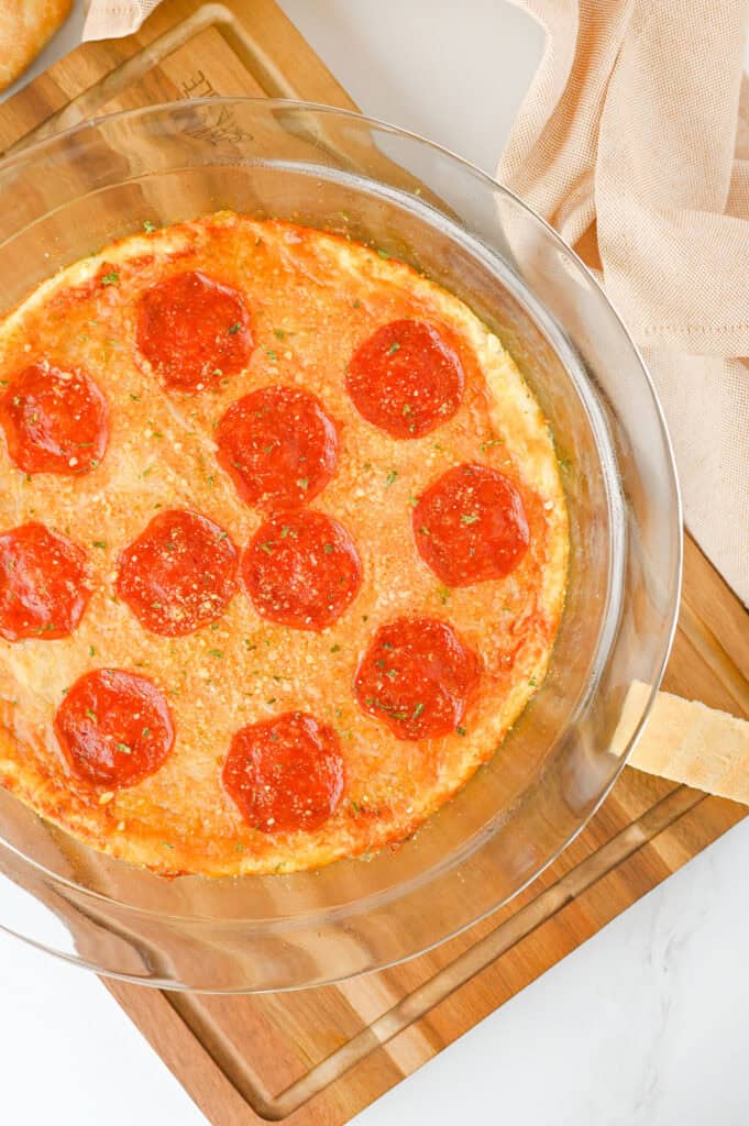 overhead shot of baked pepperoni pizza dip in a dish