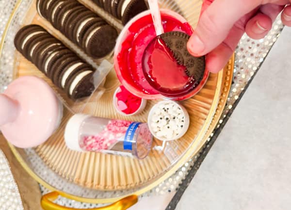 dip each cookie into frosting or melted candy