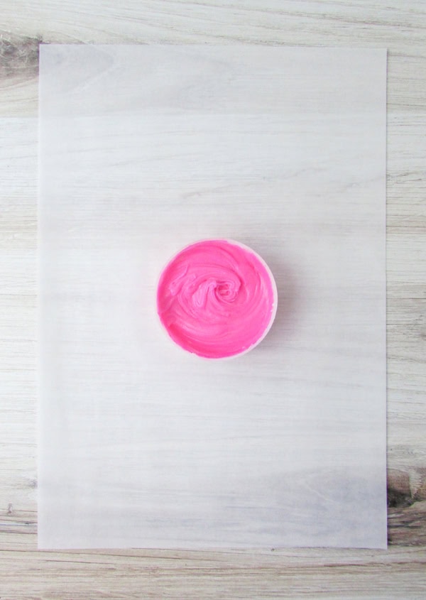 add pink food coloring to icing and stir well