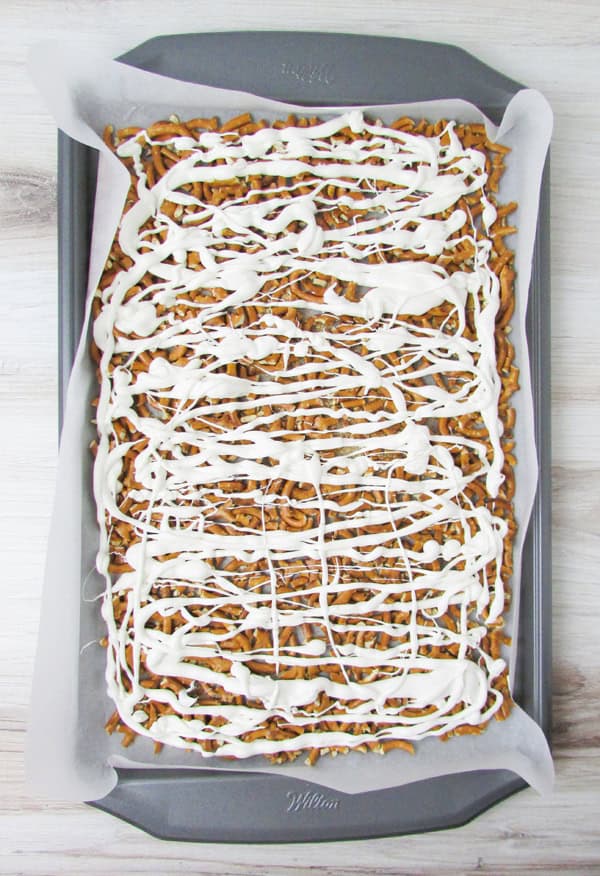 drizzle white candy across the pretzel pieces