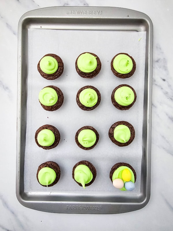 pipe icing on each brownie bite and add candy eggs
